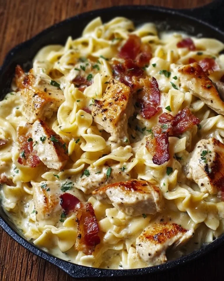 Creamy Chicken Bacon Ranch Pasta topped with fresh herbs and crispy bacon.