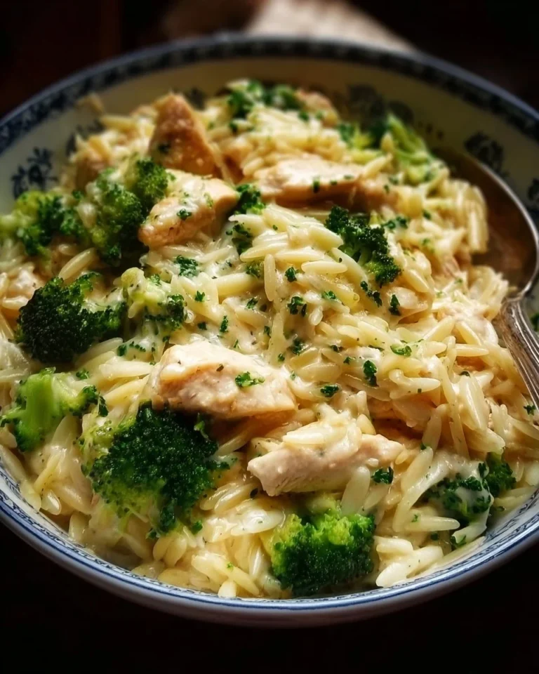 Creamy cheesy chicken and broccoli orzo served in a bowl