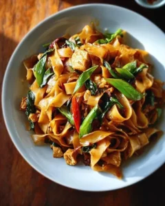 Delicious plate of Drunken Noodles with vegetables and protein