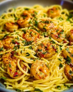 Plate of easy garlic shrimp pasta with herbs and parmesan cheese
