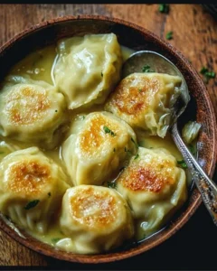 Plate of German cabbage dumplings garnished with fresh herbs