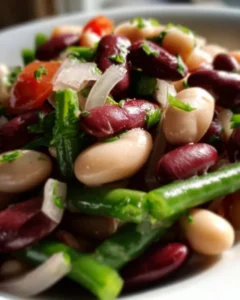 Colorful Three Bean Salad with mixed beans, vegetables, and dressing