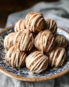 Cinnamon roll protein bites stacked on a plate, delicious and nutritious snack
