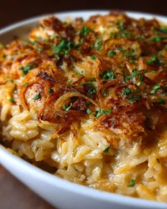 French Onion Chicken Orzo Casserole in a baking dish topped with melted cheese