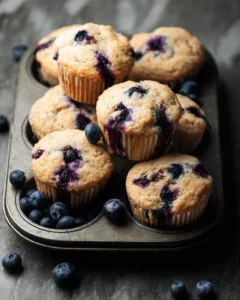 Freshly baked homemade blueberry protein muffins on a baking tray