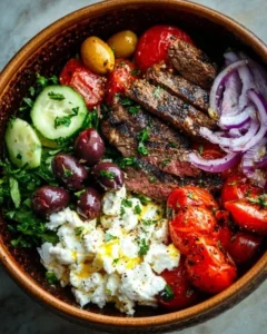 Delicious Mediterranean steak bowl with fresh vegetables and herbs