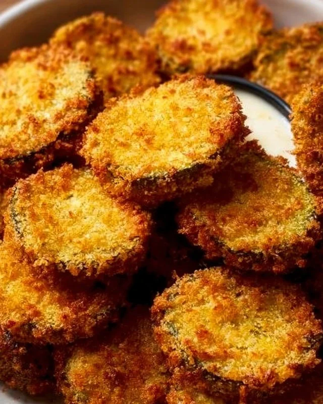 A plate of crispy air fryer fried pickles served with dipping sauce