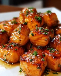 Air fryer honey garlic salmon bites plated with garnish