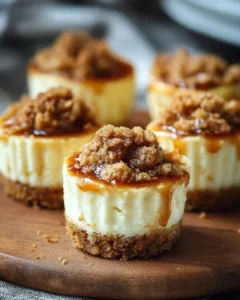 Delicious Apple Crisp Mini Cheesecakes topped with apples and crumble
