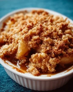 Delicious baked apple crumble topped with golden crispy oats and fresh apple slices.