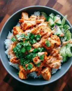 Delicious Bang Bang Chicken Bowl topped with fresh vegetables and sauce