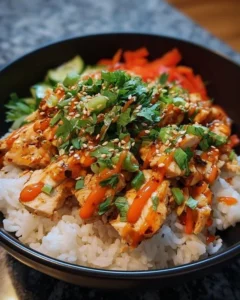 Bang Bang Chicken Bowl garnished with fresh herbs and spices.