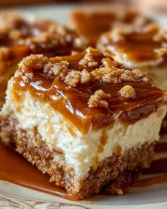 Decadent Caramel Apple Cheesecake Bars topped with caramel sauce and apple slices