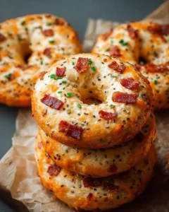 Creamy Bacon Cheddar Bagels topped with melting cheese and crispy bacon