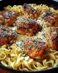 One-pan chicken with buttered noodles served in a vibrant dish.