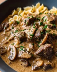 Gordon Ramsay's delicious Beef Stroganoff served with noodles and garnished with parsley.