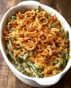 Homemade green bean casserole topped with crispy onions and served in a dish.