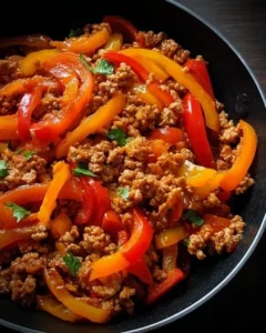 A colorful dish of ground turkey and peppers, showcasing a healthy meal option.