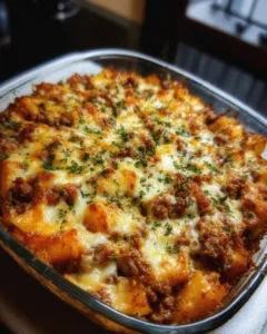 Delicious Hobo Casserole served in a baking dish with fresh herbs and vegetables.