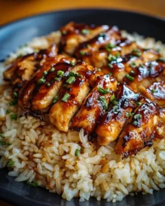 Plate of Honey BBQ Chicken served with rice and garnished with herbs