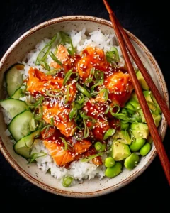Delicious Honey Sriracha Salmon bowls with fresh vegetables and rice.