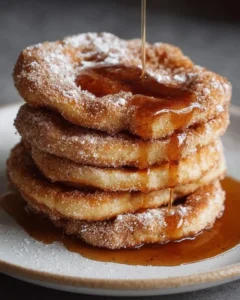 Fluffy churro pancakes dusted with cinnamon sugar and drizzled with chocolate sauce