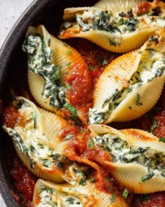 Plate of Vegan Stuffed Shells filled with plant-based ricotta and topped with marinara sauce.