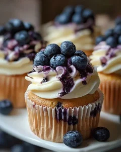 Delicious white chocolate blueberry cupcakes topped with fresh blueberries