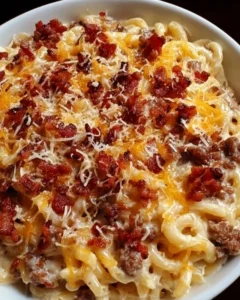 Delicious Bacon Cheeseburger Alfredo served in a creamy sauce with bacon and cheeseburger toppings.