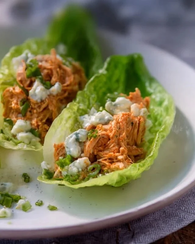 Buffalo Chicken Lettuce Wraps served on a plate with fresh vegetables