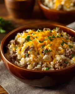 Cheesy Hamburger Rice Casserole served in a bowl with toppings.