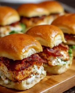Delicious Chicken Bacon Ranch Sliders topped with crispy bacon and creamy ranch sauce