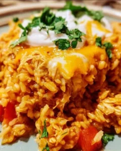 Chicken Enchilada Rice Casserole topped with cheese and fresh ingredients