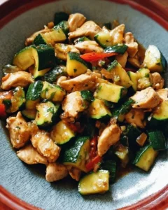 Colorful chicken zucchini stir fry with vegetables in a skillet