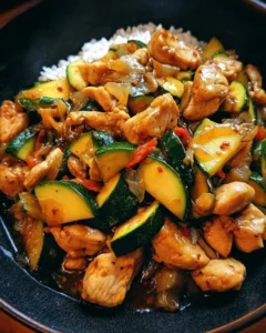 Delicious chicken zucchini stir fry served in a bowl with fresh vegetables