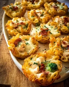 Creamy chicken and broccoli pasta bake topped with cheese in a casserole dish.