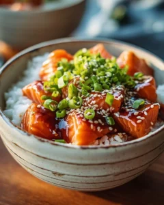 A delicious crispy salmon served over a bed of rice with fresh vegetables.