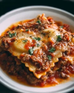 Delicious Crockpot Ravioli Lasagna served in a bowl with melted cheese and sauce
