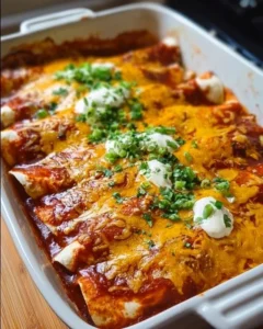 Plate of delicious chicken enchiladas topped with cheese and sauce