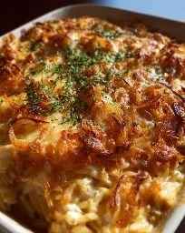 French Onion Chicken Orzo Casserole topped with cheese and herbs
