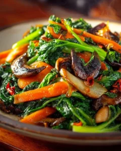 Colorful platter of healthy sautéed vegetables including bell peppers, broccoli, and carrots