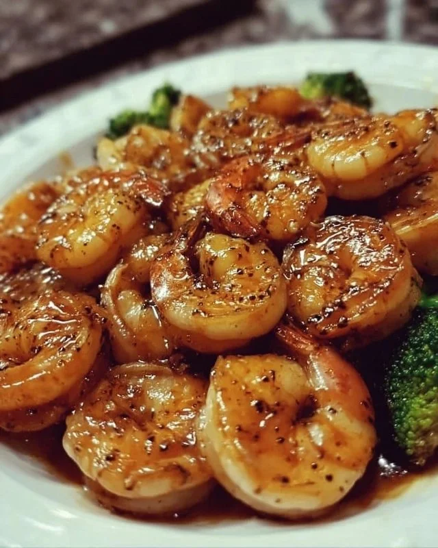 High-protein honey garlic shrimp served on a plate with vegetables