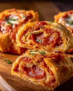High protein pepperoni pizza rolls stacked on a plate ready to enjoy.