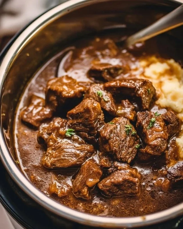 Delicious Instant Pot beef tips served with sauce and garnished.