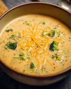 Delicious Instant Pot Broccoli Cheddar Soup garnished with cheese and herbs