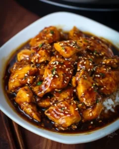 Instant Pot Honey Garlic Chicken served on a plate with garlic cloves and herbs