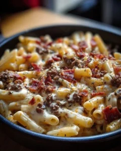 Loaded Bacon Cheeseburger Alfredo Pasta topped with crispy bacon and melted cheese