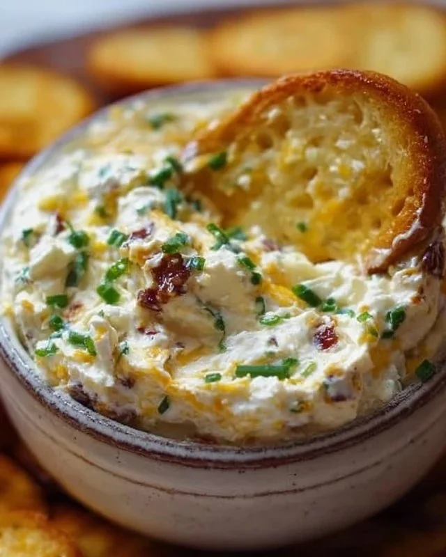 Delicious Million Dollar Dip served in a bowl with fresh vegetables