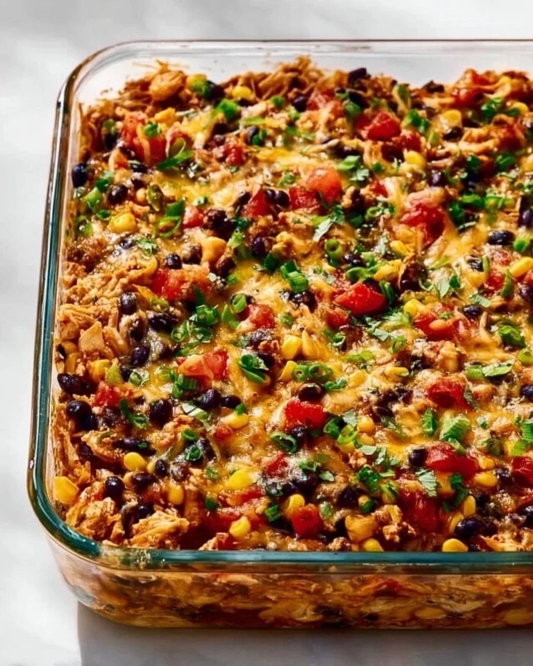 Delicious protein burrito casserole topped with cheese and fresh ingredients.