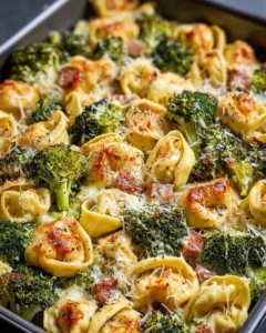 Sheet pan broccoli tortellini bake with fresh vegetables and melted cheese